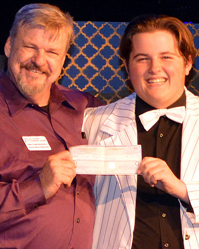 Mike Rademaekers prises Charles McLean by awarding him $1,000.00 from HCCT’s Phil Holbert Scholarship fund before the opening curtain of “Dirty Rotten Scoundrels” on Friday, July 26.